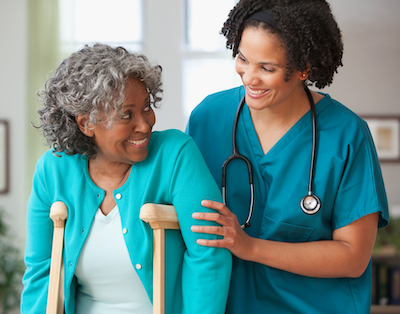 Nurse helping patient with crutches