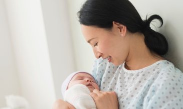 A mother holding her newborn baby