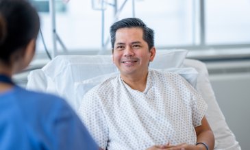 A male patient talking to a female nurse