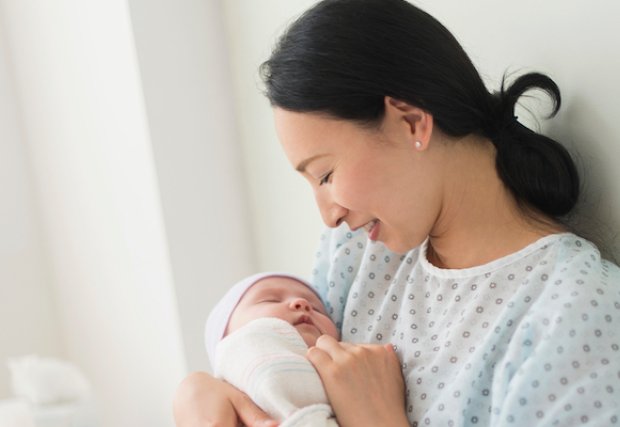 A mother holding her newborn baby