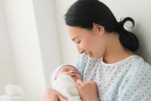 A mother holding her newborn baby