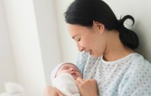 A mother holding her newborn baby